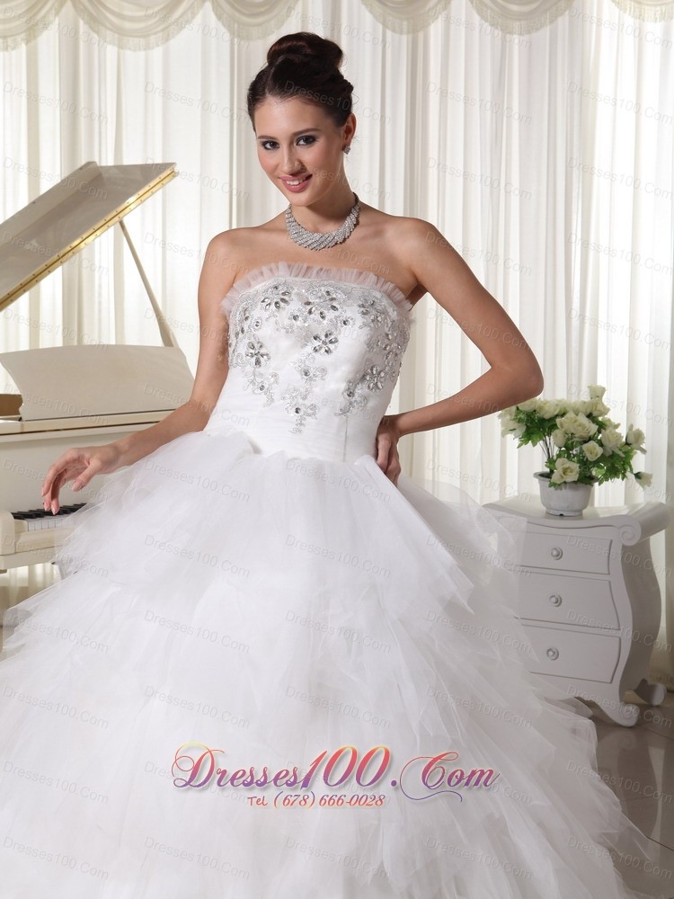 A-line Strapless Beaded Bridal Gown Tulle Ruffles Sweep Train